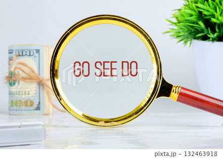 A magnifying glass focuses on the phrase GO SEE DO, encouraging exploration and adventure. Nearby, a stack of cash and a green plant suggest opportunities awaiting discovery A magnifying glass focuses on the phrase GO SEE DO, encouraging exploration and adventure. Nearby, a stack of cash and a green plant suggest opportunities awaiting discovery 132463918