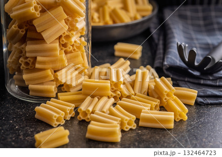 Cinque buchi. Uncooked italian pasta on black table. 132464723
