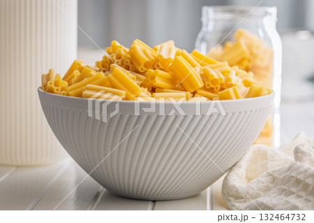 Cinque buchi. Uncooked italian pasta in bowl on white table. Cinque buchi. Uncooked italian pasta in bowl on white table. 132464732