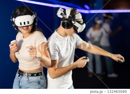 Guy and girl playing against another couple in a game Guy and girl playing against another couple in a game 132465089