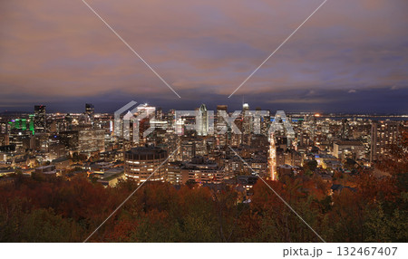 Aerial Montreal skyline illuminated at dusk with autumn colors and Saint Lawrence River on on the background, Canada 132467407