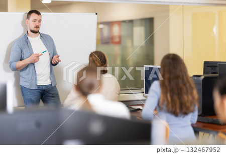 Young man giving presentation in office Young man giving presentation in office 132467952