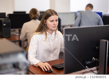 Young woman working on computer in office 132468035