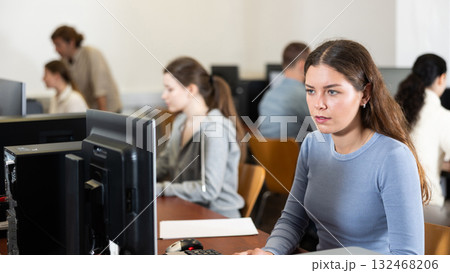Young woman working on computer in office 132468206