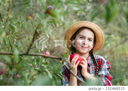 Beautiful girl apple in organic apples in orchard. Girl eating organic apple in garden. Beautiful girl apple in organic apples in orchard. Girl eating organic apple in garden. 132468515