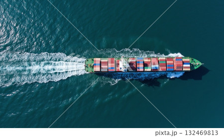 Aerial View of Container Ship Navigating Through Deep Blue Ocean Water 132469813