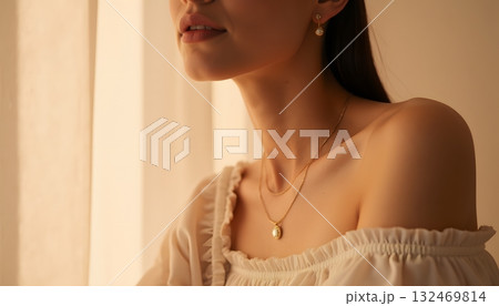 Elegant Woman with Jewelry in Soft Natural Light While Posing by a Window Elegant Woman with Jewelry in Soft Natural Light While Posing by a Window 132469814