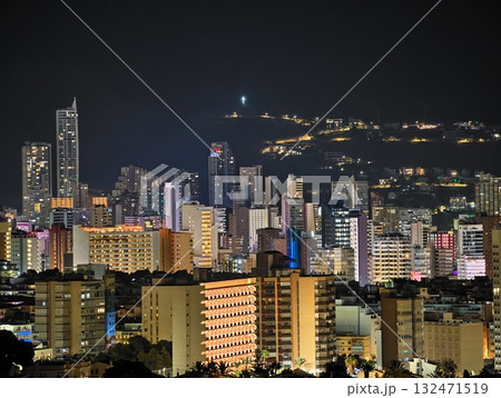 dusk illuminates dense apartment complexes and skyscrapers creating lively urban silhouette 132471519