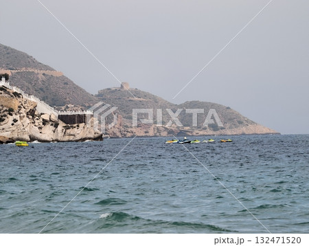 serene coastal scene, tranquil marine setting where cliffs meet turquoise waters and kayaks await serene coastal scene, tranquil marine setting where cliffs meet turquoise waters and kayaks await 132471520