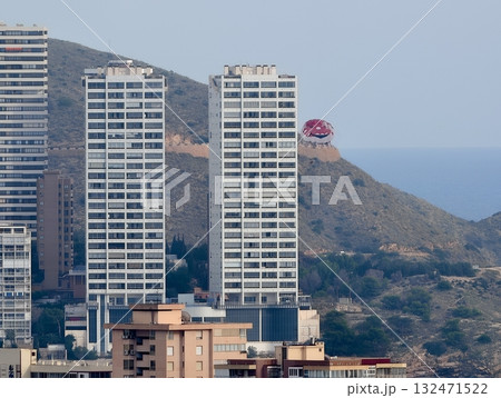 concrete apartment structures with balconies and reflective glass midst natural hillside concrete apartment structures with balconies and reflective glass midst natural hillside 132471522