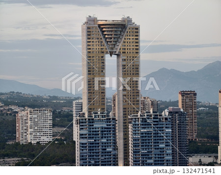 stylish building with angular glass facade overlooking city and surrounding natural landscape 132471541