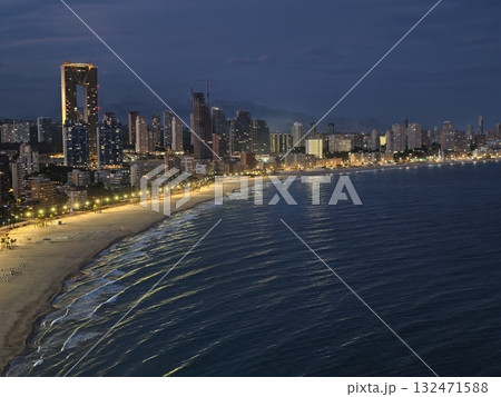 nighttime coastal panorama, cinematic view of urban coastlines at twilight illuminated by city 132471588