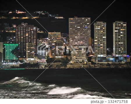 luminous skyline with diverse architecture reflected in tranquil waters during lively nocturnal 132471758