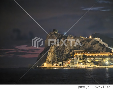 lighthouse overlooking peaceful rocky coast, scenic nighttime setting with glowing lights lighthouse overlooking peaceful rocky coast, scenic nighttime setting with glowing lights 132471832