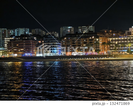 vibrant harbor evening, bustling waterfront at night with illuminated restaurants and moving boats vibrant harbor evening, bustling waterfront at night with illuminated restaurants and moving boats 132471869