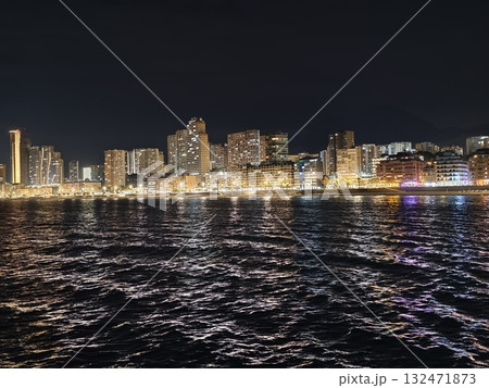 luminous skyline with diverse architecture reflected in tranquil waters during lively nocturnal 132471873