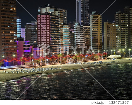 vibrant waterfront walkway, colorful street along water with lively illuminated attractions 132471897