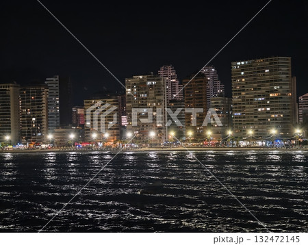 quiet harbor cityscape at night featuring glowing windows and gently rippling sea reflections quiet harbor cityscape at night featuring glowing windows and gently rippling sea reflections 132472145