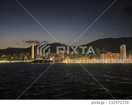 coastal night scene, nighttime coastal landscape featuring luminous skyline and tranquil reflections coastal night scene, nighttime coastal landscape featuring luminous skyline and tranquil reflections 132472150