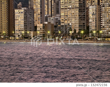evening city by pink shoreline, modern cityscape illuminated with reflections on tranquil harbor evening city by pink shoreline, modern cityscape illuminated with reflections on tranquil harbor 132472156