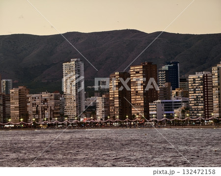 peaceful coastal landscape with radiant sunlight, quiet seaside town bathed in warm evening peaceful coastal landscape with radiant sunlight, quiet seaside town bathed in warm evening 132472158