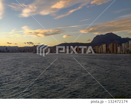 pastel skies over tranquil shoreline, bright horizon with shimmering reflections on peaceful water pastel skies over tranquil shoreline, bright horizon with shimmering reflections on peaceful water 132472174