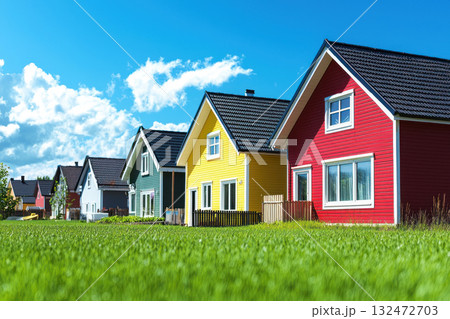 Colorful houses in sunny neighborhood with green grass and blue sky Colorful houses in sunny neighborhood with green grass and blue sky 132472703