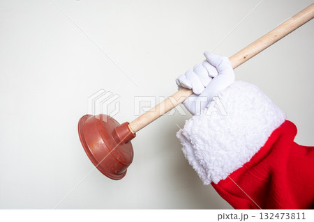 Santa's hands using a toilet plunger Santa's hands using a toilet plunger 132473811