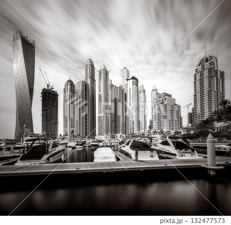 Panoramic view of Dubai Marina bay with yacht and cloudy sky, Dubai, UAE 132477573