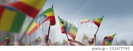 Ethiopia flags in their hands on a blurred urban background 132477745