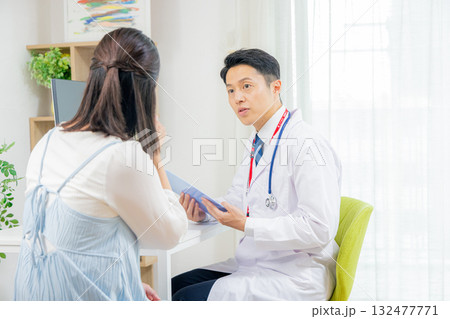 患者と診察する医師 132477771