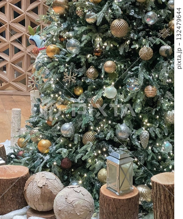 A beautifully decorated Christmas tree with twinkling lights, colorful ornaments, and a star on top. A symbol of warmth and joy, perfect for celebrating the holiday season. 132479644