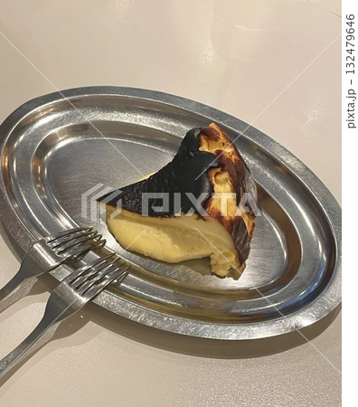Rich and creamy burnt cheesecake with a caramelized top and a soft, velvety center. A perfect balance of deep, toasty flavor and smooth texture for an indulgent dessert. 132479646