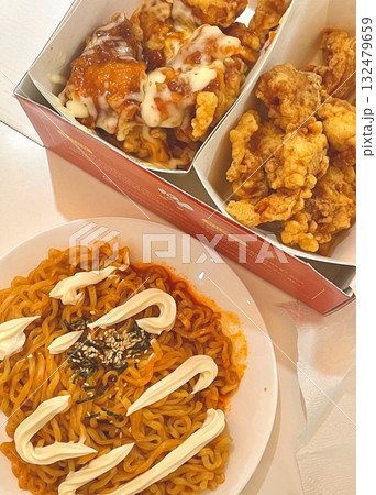 Crispy Korean fried chicken with sweet and spicy glaze paired with fiery buldakmyeon noodles, offering a perfect explosion of bold heat, rich flavor, and satisfying crunch in every bite. Crispy Korean fried chicken with sweet and spicy glaze paired with fiery buldakmyeon noodles, offering a perfect explosion of bold heat, rich flavor, and satisfying crunch in every bite. 132479659