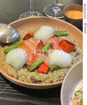Creamy risotto cooked to perfection with rich, buttery texture and savory flavors. A classic Italian dish perfect for gourmet menus, food blogs, and elegant dining promotions. 132479748