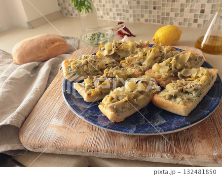 Bruschetta on plate with boiled artichokes. Healthy eating and traditional Italian dish. Fresh, seasonal farm produce. 132481850