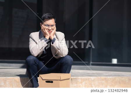 Concept of business failure and unemployment problem, unemployment stress businessman sitting on stairs. Concept of business failure and unemployment problem, unemployment stress businessman sitting on stairs. 132482946