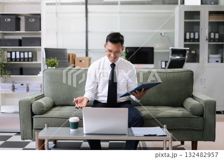 Mature businessman calculate and analyzing graph document financial with report and laptop in office. 132482957