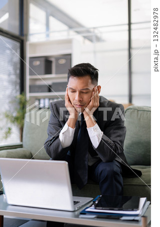 stressed Asian businessman working in the office. Businessman thinking too much work concept in the office. stressed Asian businessman working in the office. Businessman thinking too much work concept in the office. 132482978