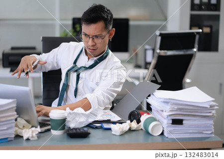 stressed Asian businessman working in the office. Businessman thinking too much work concept in the office. 132483014