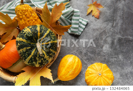 Assorted pumpkins gourds and autumn leaves celebrating fall harvest 132484065