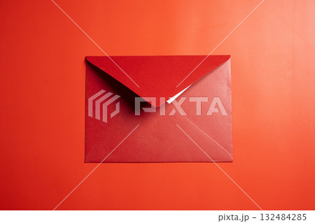 Top view of red envelope or postcard on red background. Mockup, blank template, copy space. Greeting or invitation card with flat lay style Top view of red envelope or postcard on red background. Mockup, blank template, copy space. Greeting or invitation card with flat lay style 132484285