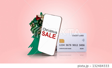 Christmas sale text on cellphone screen with credit card and Christmas tree ornament on colored background. Copy space. Christmas sale concept Christmas sale text on cellphone screen with credit card and Christmas tree ornament on colored background. Copy space. Christmas sale concept 132484333