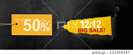Top view of black ripped paper and text of 12.12 big sale with up to 50% text on the label tag. Copy space. Flash sale concept 132484347