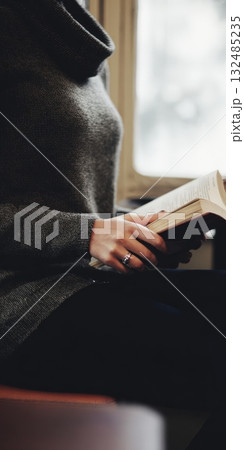 Woman reading book, enjoying quiet hobby indoors 132485235