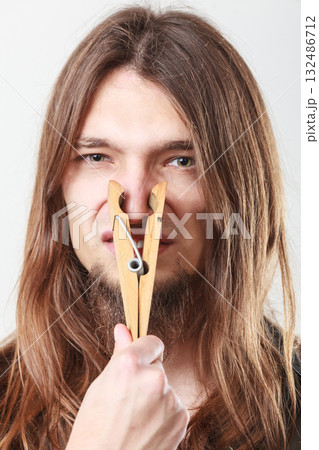 Man with clogged nose by clothespin 132486712