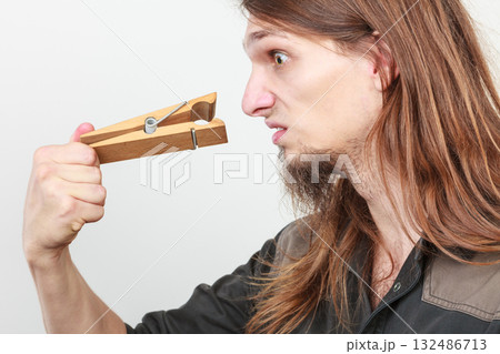 Man with clogged nose by clothespin Man with clogged nose by clothespin 132486713