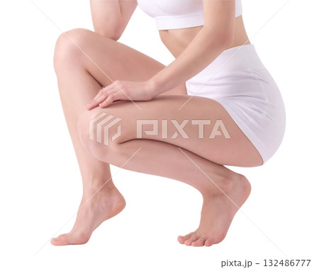 Girl sits squatting in light short clothes close up 132486777