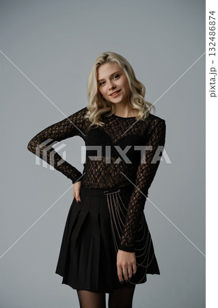 Elegant young woman poses in stylish outfit showcasing modern fashion and confidence 132486874
