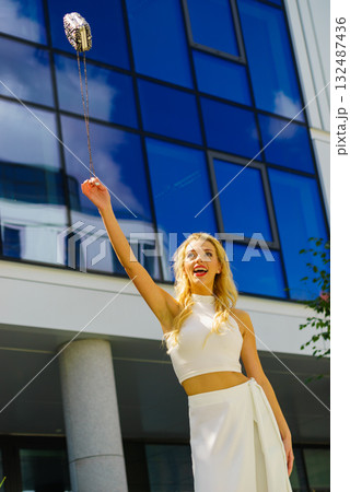 Cheerful fashionable woman in city Cheerful fashionable woman in city 132487436